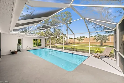 a view of a backyard with a table and chairs