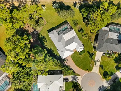an aerial view of a house with a yard and garden