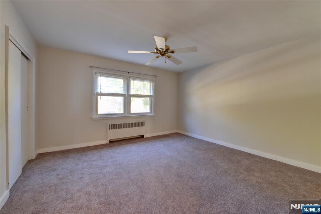 255 Bogert Road, Unit 2A River Edge, NJ 07661 - Photo 11 of 25 an empty room with a window and a ceiling fan