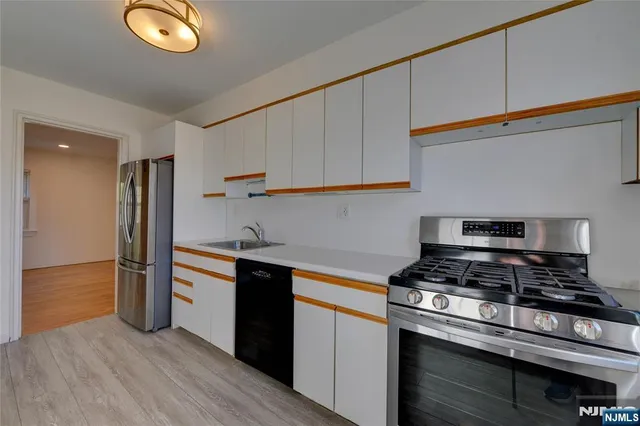 a kitchen with stainless steel appliances granite countertop a stove and a refrigerator