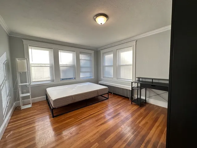 a view of an empty room and wooden floor
