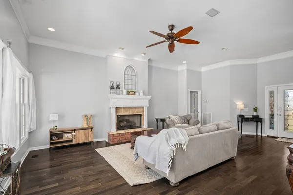 a living room with furniture and a wooden floor