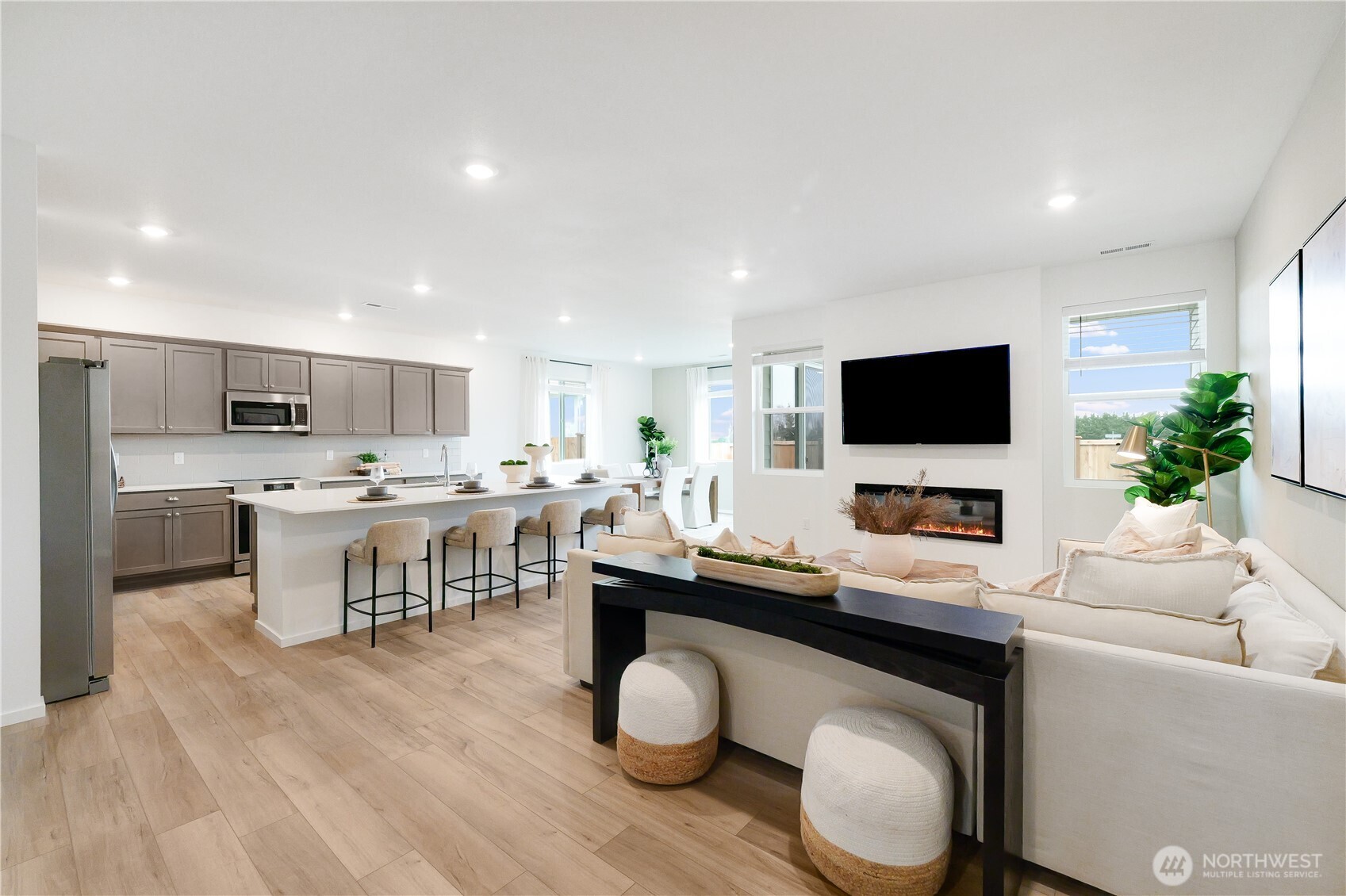 72 Moonshadow Lane Sequim, WA 98382 - Photo 11 of 27 a living room with stainless steel appliances kitchen island granite countertop a sink and a stove top oven with wooden floor