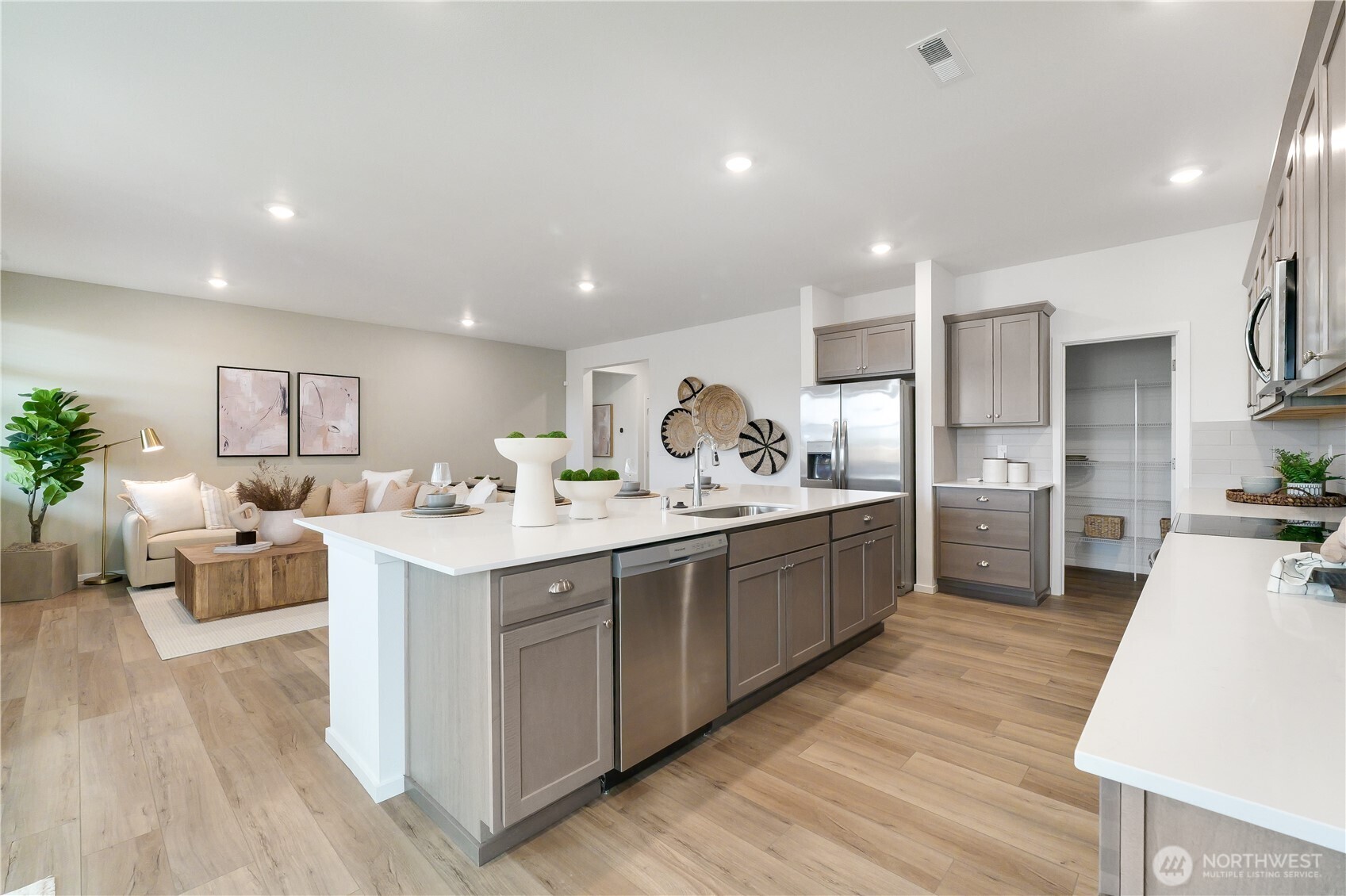 72 Moonshadow Lane Sequim, WA 98382 - Photo 3 of 27 a large kitchen with kitchen island a sink a counter space and stainless steel appliances