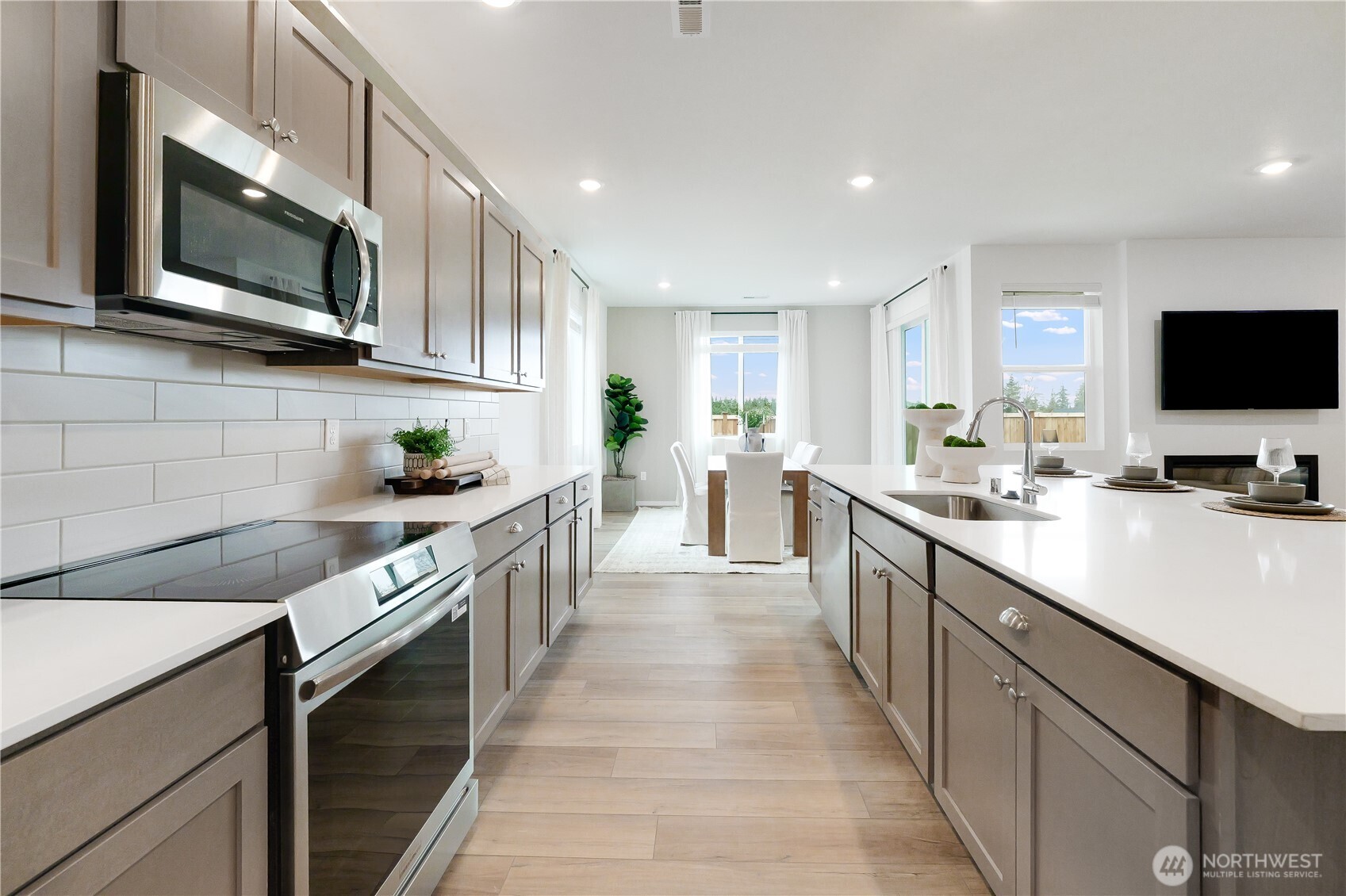 72 Moonshadow Lane Sequim, WA 98382 - Photo 6 of 27 a kitchen with stainless steel appliances granite countertop a sink and dishwasher a stove top oven with wooden floor