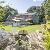 a view of a house with swimming pool and porch with furniture