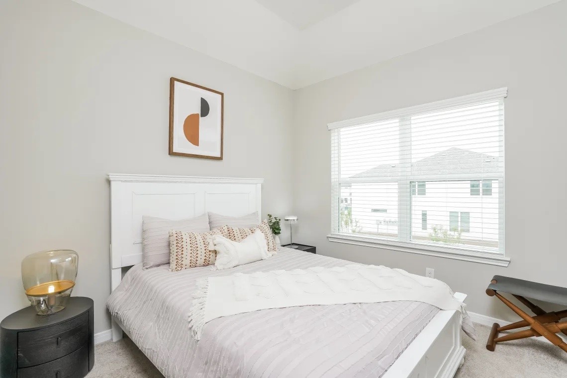 21455 Merchant's Way, Unit 103 Katy, TX 77449 - Photo 11 of 20 a bedroom with a bed and wooden floor