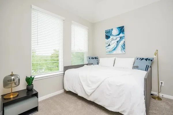 a bedroom with a bed and a window