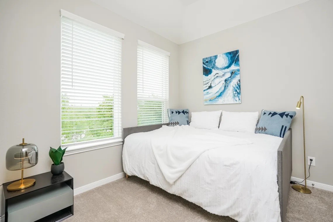 21455 Merchant's Way, Unit 103 Katy, TX 77449 - Photo 12 of 20 a bedroom with a bed and a window