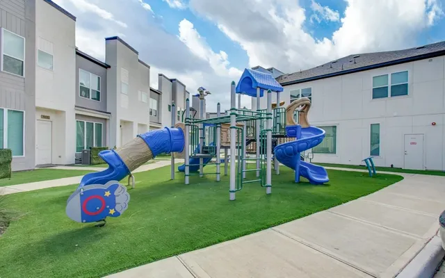 a childrens park with lots of swings and slides
