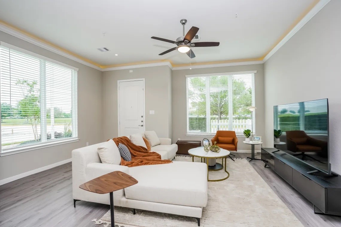 21455 Merchant's Way, Unit 103 Katy, TX 77449 - Photo 4 of 20 a living room with furniture and a flat screen tv