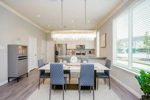 a view of a dining room with furniture window and wooden floor