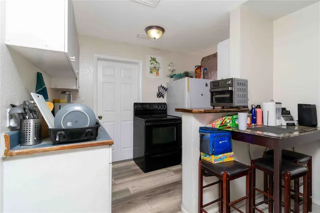 a kitchen with granite countertop a sink appliances and cabinets