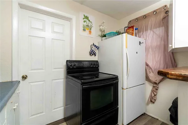 a kitchen with a refrigerator and a stove top oven