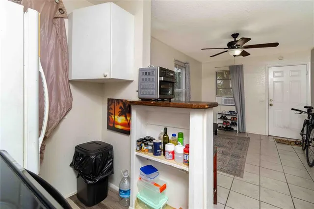 a kitchen with stainless steel appliances furniture and a refrigerator
