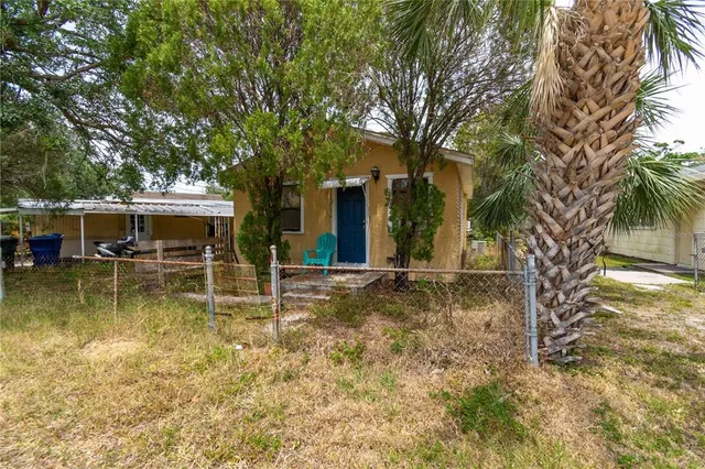 a view of an house with swimming pool and sitting area