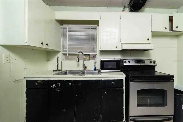 a kitchen with a sink and cabinets