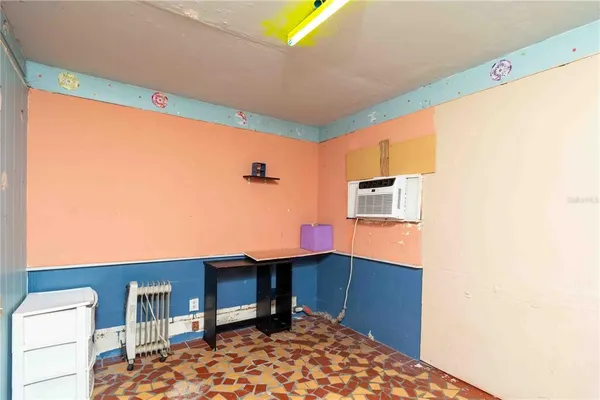 a view of a chair and table in backyard of the house