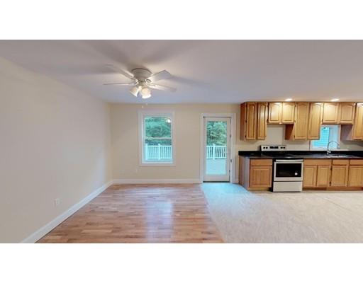 561 Black Brook Road Goffstown, NH 03045 - Photo 17 of 36 a open kitchen with stainless steel appliances kitchen island a large counter top and a sink