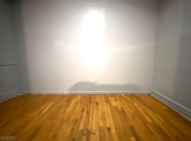 a view of room with wooden floor and window