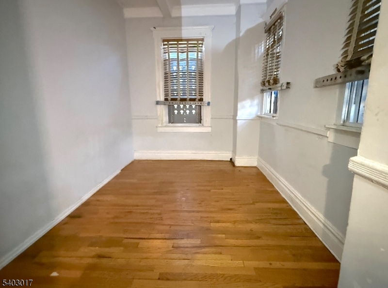 66 Scheerer Avenue Newark, NJ 07112 - Photo 23 of 24 a view of a big room with wooden floor and windows