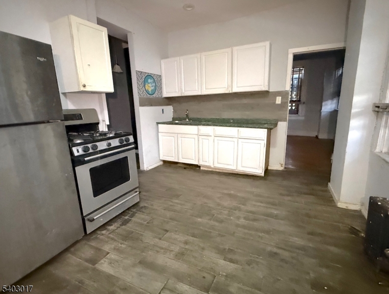 66 Scheerer Avenue Newark, NJ 07112 - Photo 8 of 24 a kitchen with granite countertop a stove a sink and a refrigerator
