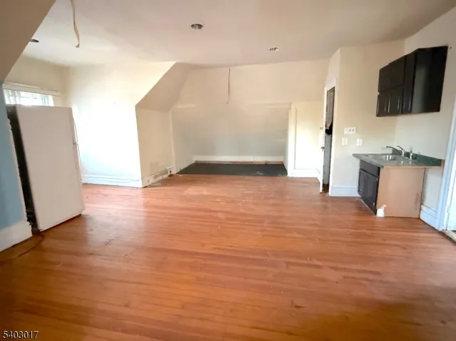 a view of a kitchen with a sink and a refrigerator