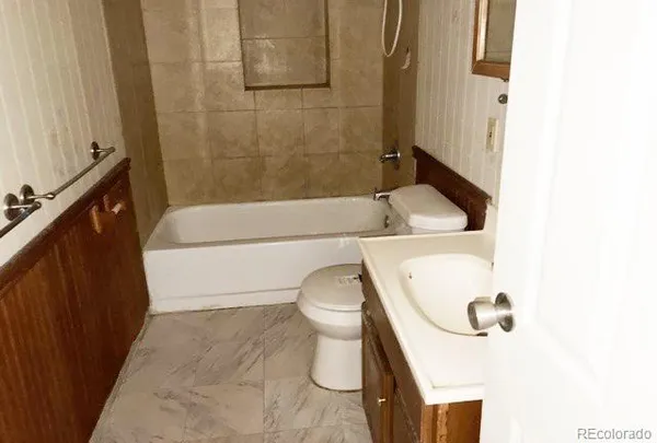 a bathroom with a sink a toilet and tub
