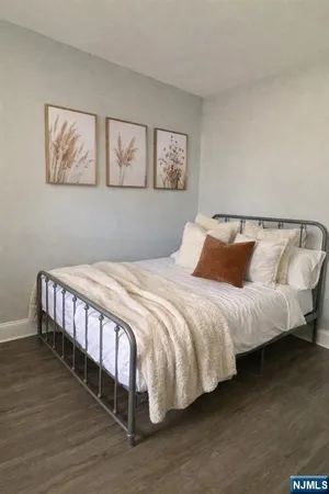 a bedroom with a bed and a night stand
