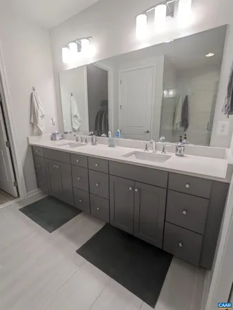 a bathroom with a double vanity sink and mirror