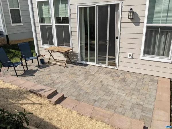 a view of house with backyard and sitting area