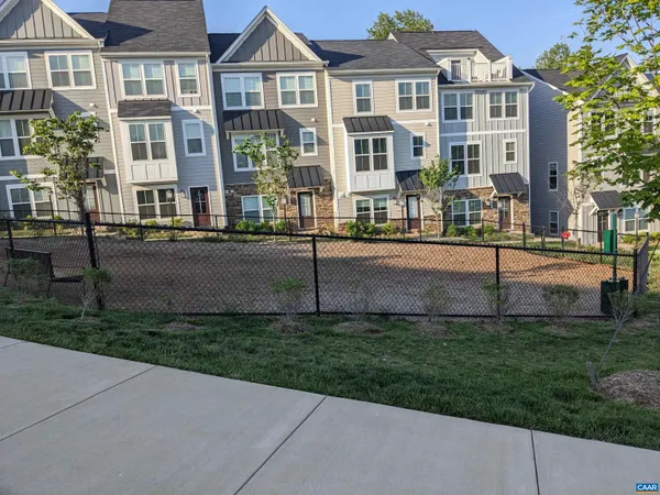 a front view of a residential apartment building with a yard