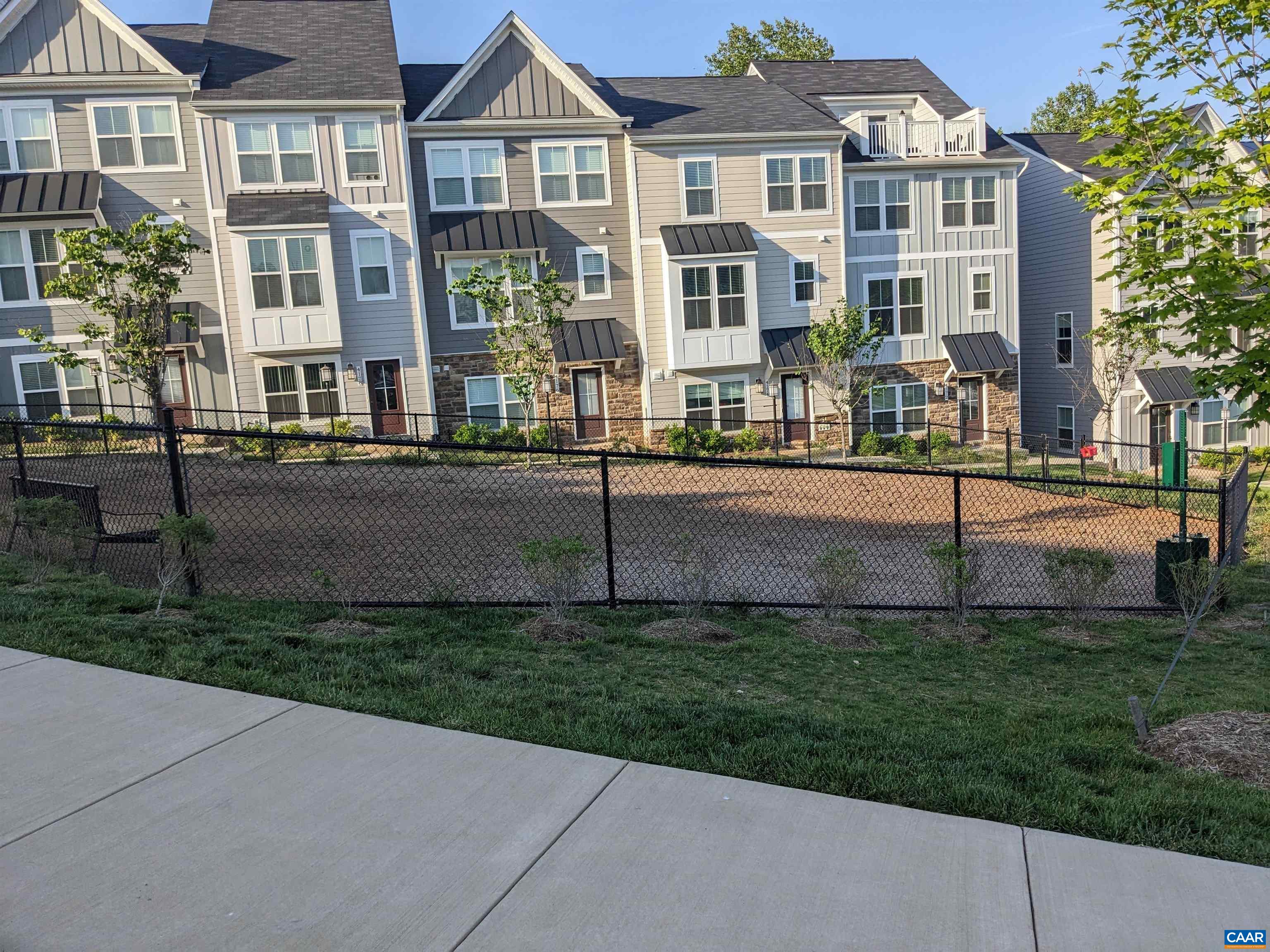 4758 Loyola Way Charlottesville, VA 22902 - Photo 17 of 26 a front view of a residential apartment building with a yard