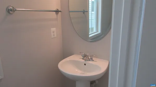 a bathroom with a sink a mirror and shower