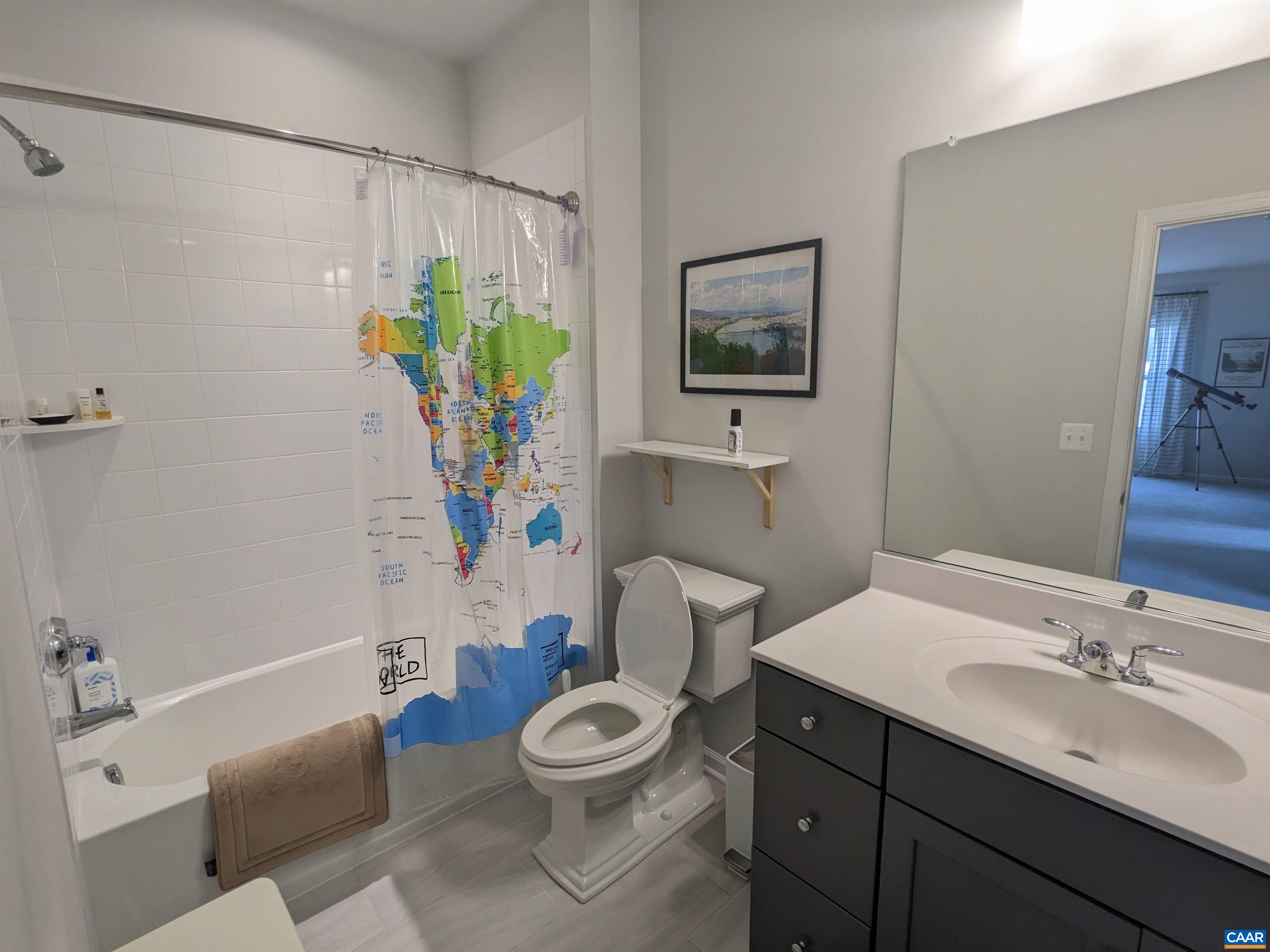 4758 Loyola Way Charlottesville, VA 22902 - Photo 8 of 26 a bathroom with a sink a mirror a toilet and a shower