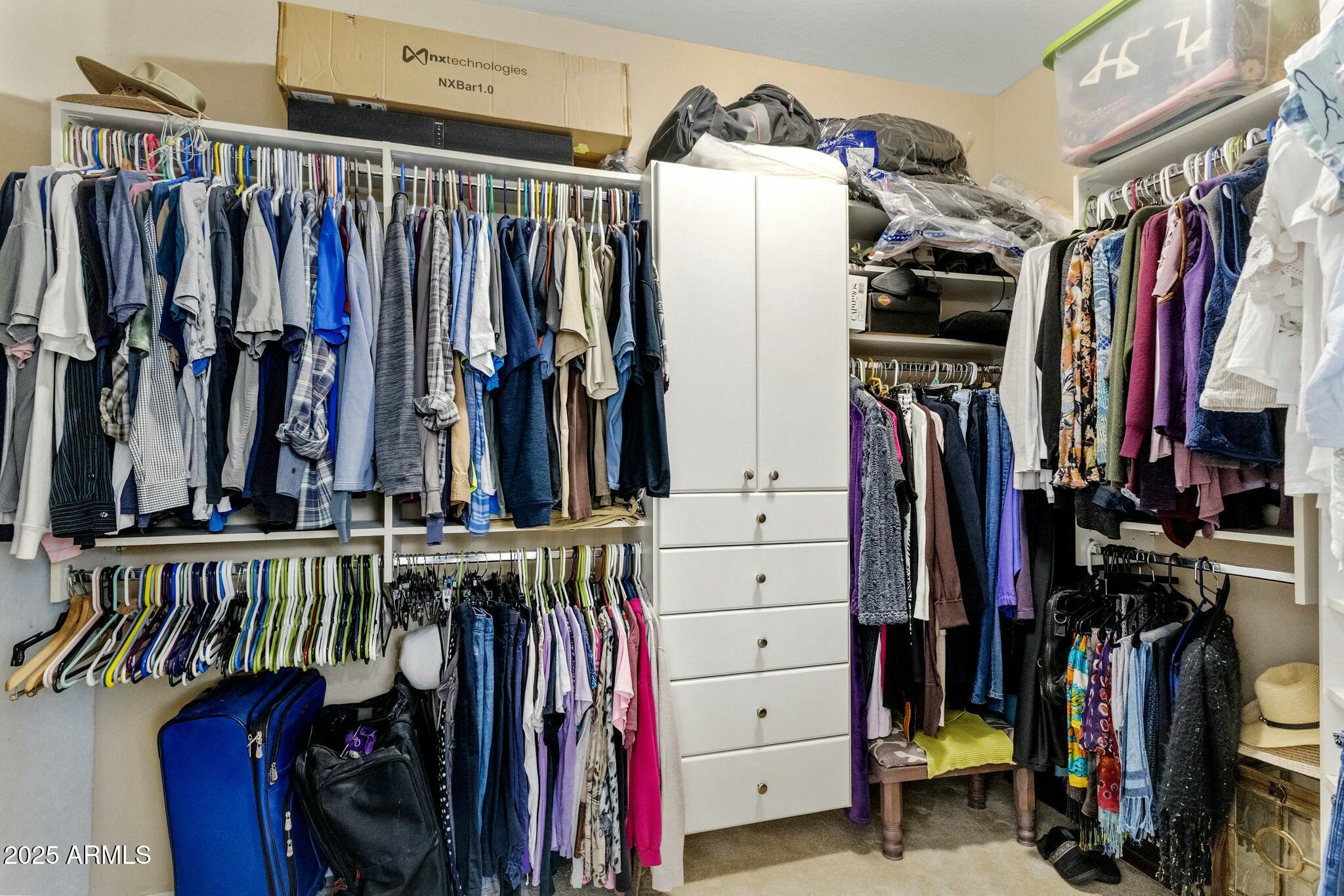20139 North Rawhide Way Surprise, AZ 85387 - Photo 22 of 30 a view of walk in closet with clothes