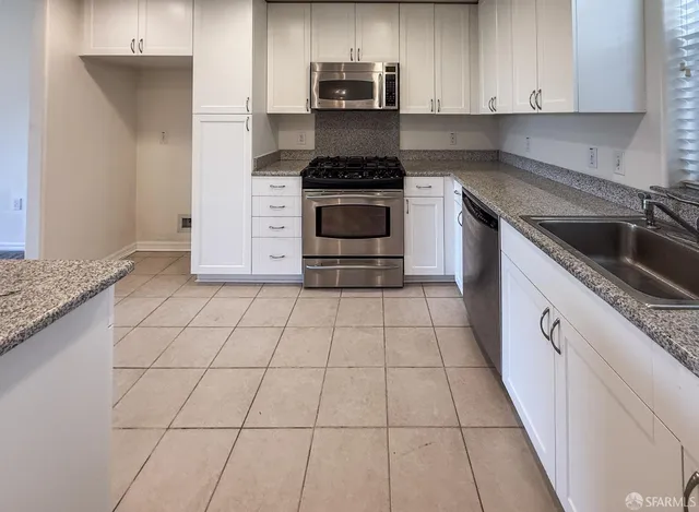 a kitchen with a stove top oven and cabinets