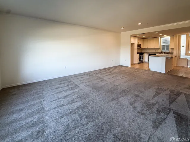 a view of a kitchen with a sink and a refrigerator