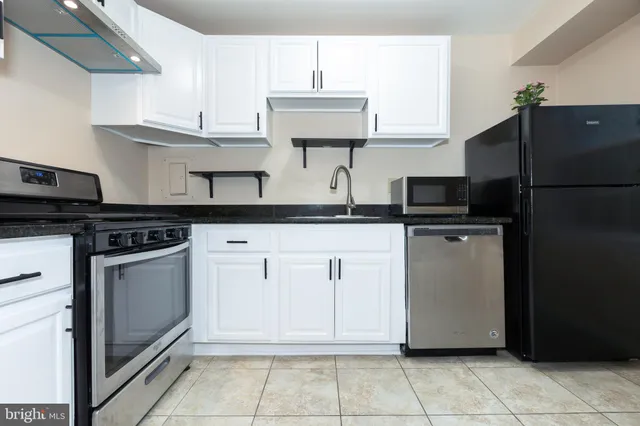 a kitchen with cabinets and stainless steel appliances