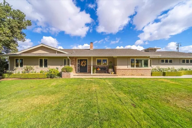 a front view of a house with swimming pool having outdoor seating
