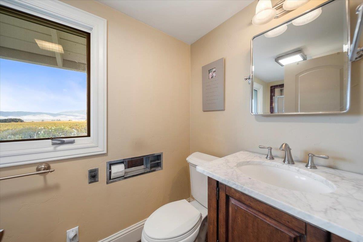 38280 Arroyo Seco Road Soledad, CA 93960 - Photo 22 of 41 a bathroom with a granite countertop toilet sink and mirror