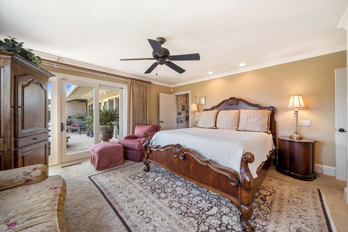 38280 Arroyo Seco Road Soledad, CA 93960 - Photo 30 of 41 a bedroom with a large bed and a chandelier