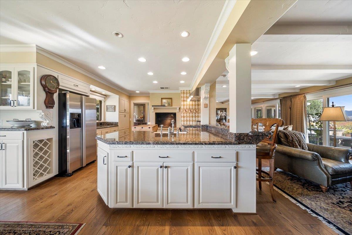 38280 Arroyo Seco Road Soledad, CA 93960 - Photo 10 of 41 a kitchen with stainless steel appliances granite countertop a lot of cabinets and wooden floor