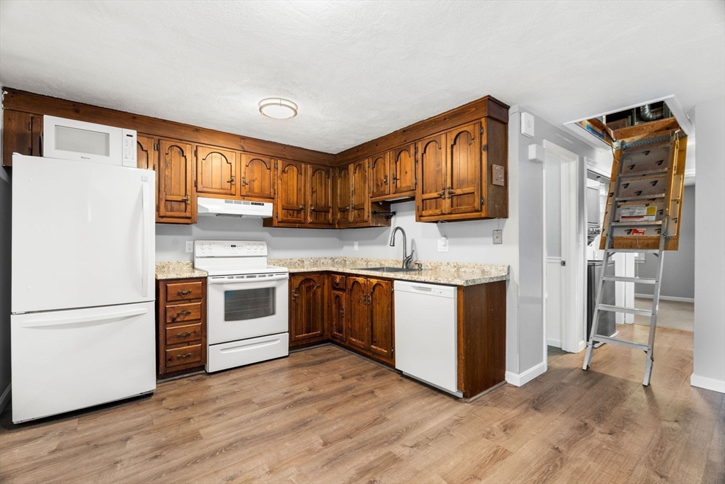 20 Washington Street, Unit 54 Methuen, MA 01844 - Photo 11 of 27 a kitchen with stainless steel appliances granite countertop a refrigerator and a stove top oven