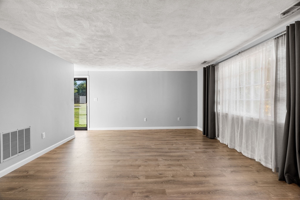 20 Washington Street, Unit 54 Methuen, MA 01844 - Photo 13 of 27 a view of an empty room with wooden floor