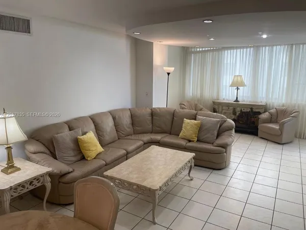 a living room with furniture and a window