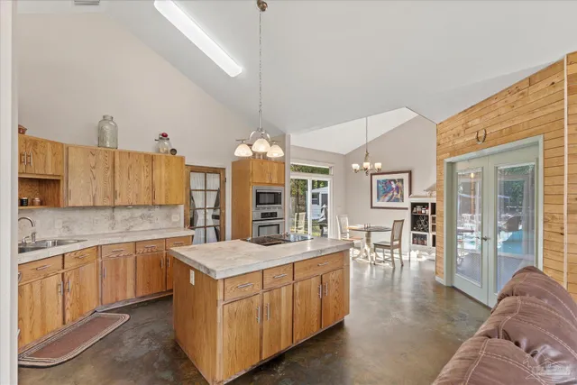 a kitchen with stove and refrigerator