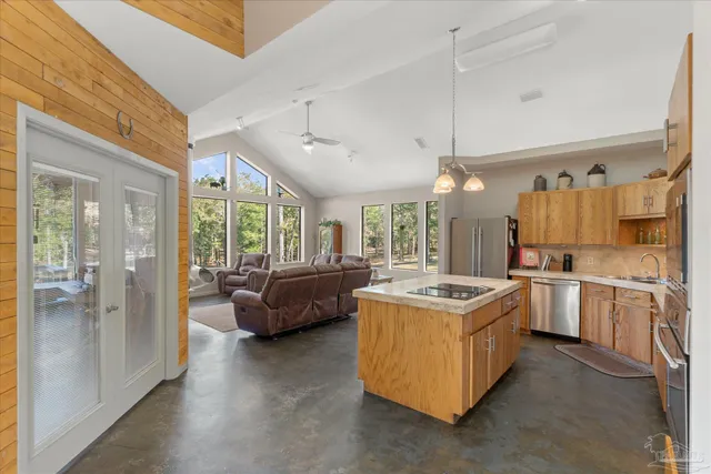 a kitchen with stainless steel appliances granite countertop a refrigerator sink and cabinets