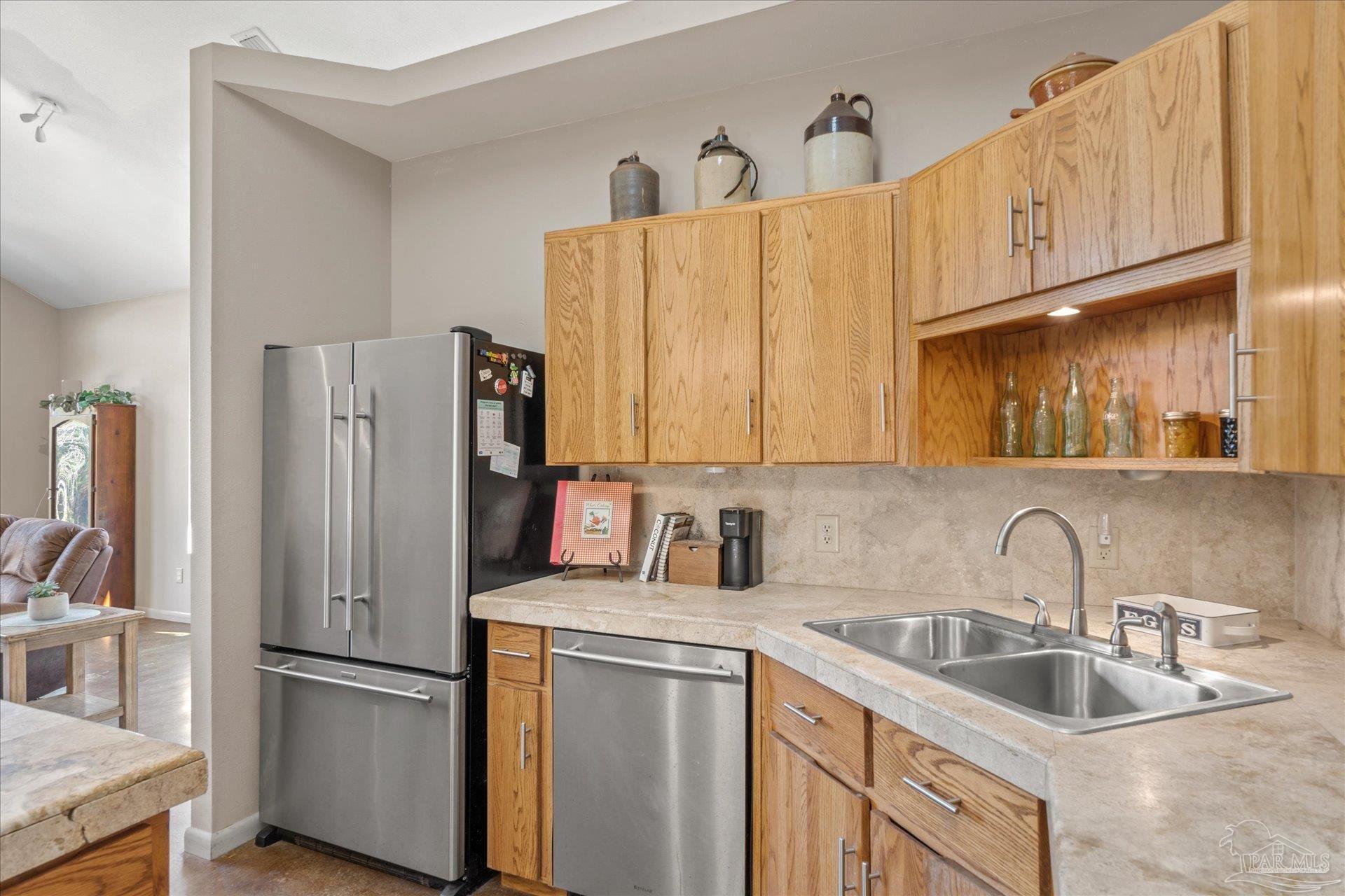 4394 Crabtree Church Road Molino, FL 32577 - Photo 16 of 70 a kitchen with stainless steel appliances granite countertop a refrigerator sink and cabinets