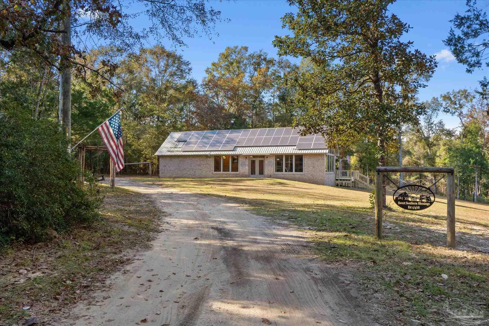 4394 Crabtree Church Road Molino, FL 32577 - Photo 2 of 70 a front view of a house with a yard